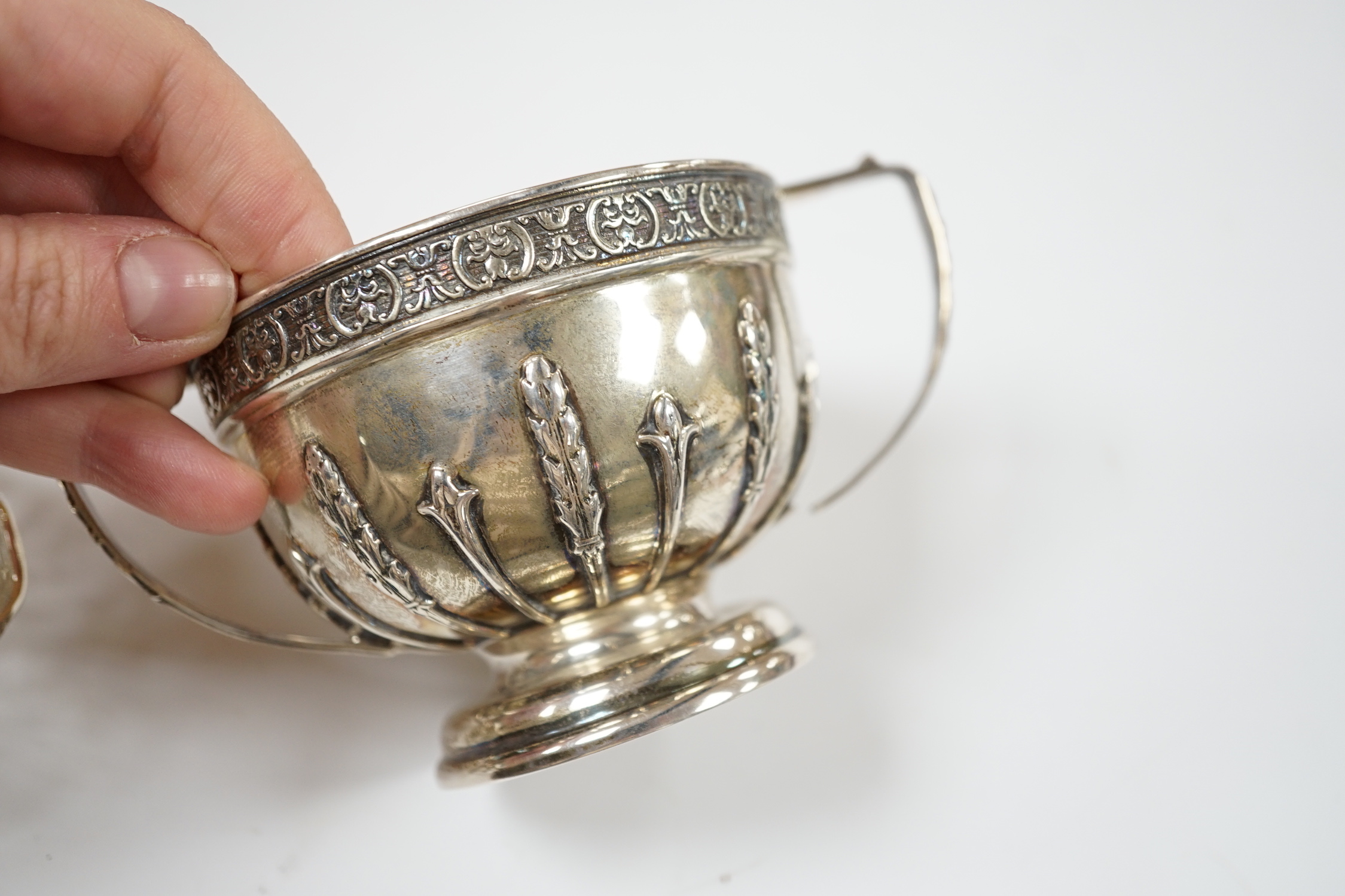 An Edwardian repousse silver porringer, Daniel & John Welby, London, 1905, diameter 92mm, a pair of pierced silver bonbon dishes, one other similar bonbon dish, a silver two handled bowl and a modern silver taste vin